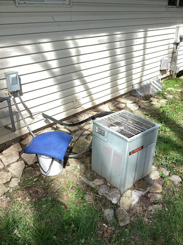 Responded to no cooling complaint on residential HVAC system. Upon arrival, documented existing equipment configuration including indoor air handler unit and outdoor condensing unit, both appearing to be 20+ years old based on visual inspection. Performed diagnostic assessment to identify cause of cooling failure and photographed equipment for service records and potential replacement recommendations due to age of system.