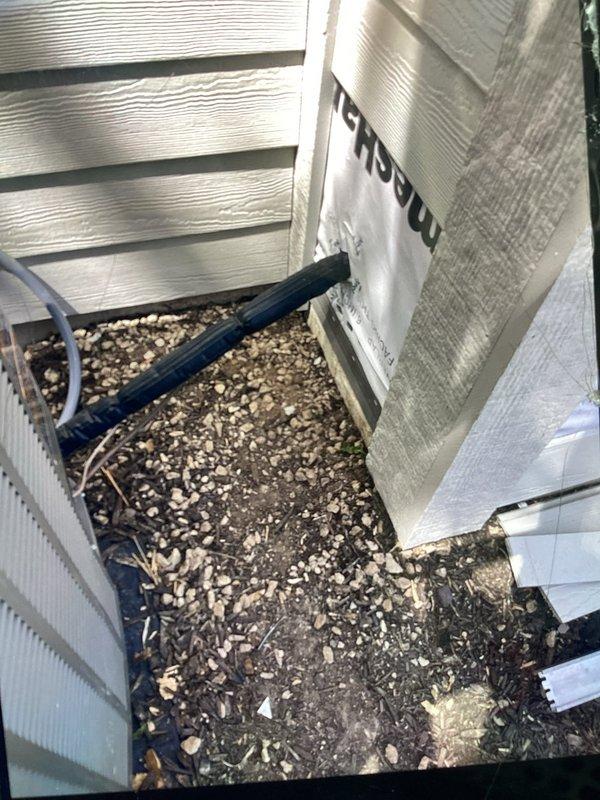 Responded to no cooling call on newly installed HVAC system where contractor accidentally drove nail through refrigerant line during construction work. Located punctured copper refrigerant line at outdoor unit, confirmed active refrigerant leak, and coordinated repair to restore system operation. Documented damage to refrigerant piping with photos showing compromised copper fitting and surrounding installation area for warranty and repair documentation purposes.