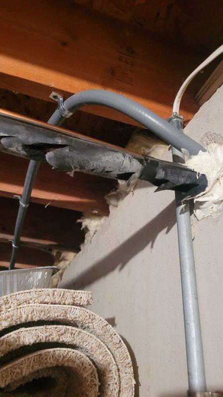 Completed comprehensive AC and furnace tune-up inspection. Identified deteriorated black refrigerant line set tubing penetrating exterior wall requiring replacement and noted missing caulking at wall penetration point that needs sealing to prevent air infiltration and moisture intrusion.