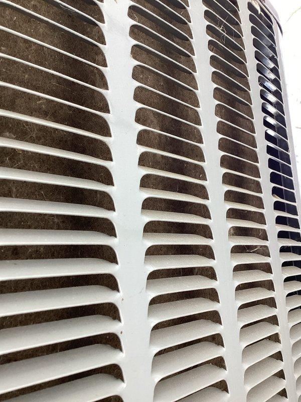 Completed annual air conditioning tune-up and maintenance inspection. Addressed customer concern regarding humidifier alert light activating intermittently; inspected humidifier system, reset controls, and verified proper operation. Documented condition of return air grille showing dust accumulation and heat exchanger coil assembly in serviceable condition.