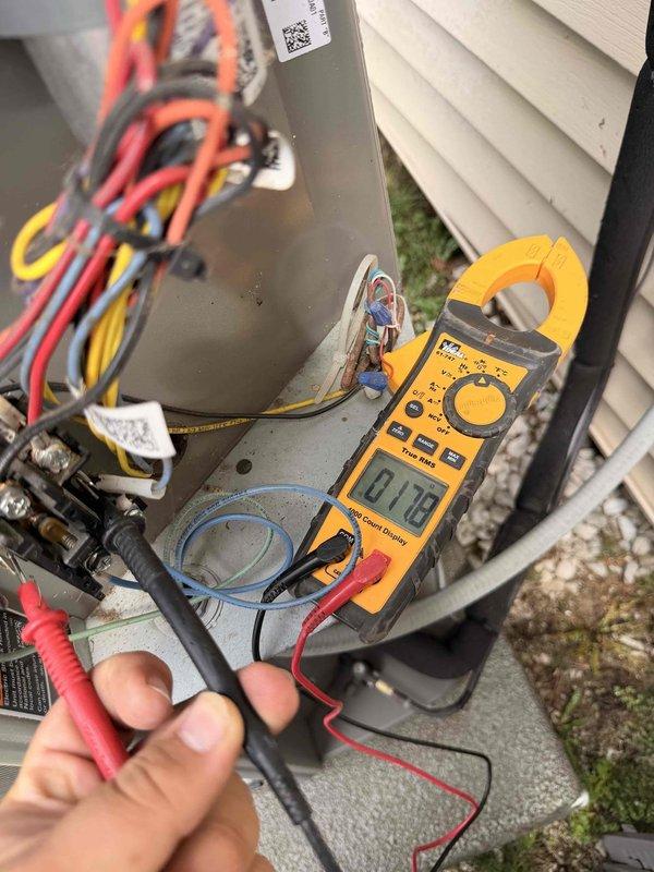 Completed scheduled bi-annual tune-up and preventive maintenance on residential outdoor condensing unit. Performed comprehensive system inspection including visual assessment of condenser coil condition, electrical connections, and unit placement. Conducted electrical diagnostics using clamp meter to verify proper amperage draw and system performance, with readings indicating normal operating parameters at 0.15 amps during testing phase. Unit operational and functioning within manufacturer specifications upon completion of service.
