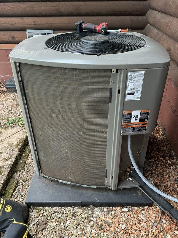 Performed membership cooling system maintenance visit on outdoor condensing unit. Upon arrival, verified previous technician's assessment regarding dirty coil condition. Inspected condenser unit and confirmed significant accumulation of dirt, dust, and debris on exterior mesh filters and coil surfaces, with heavy discoloration and clogging evident on both accessible sides. Cleaned condenser coils and filters to remove built-up contaminants and restore proper airflow through the unit. Documented equipment condition with photographs showing before state of heavily soiled components. Unit operational following cleaning service.