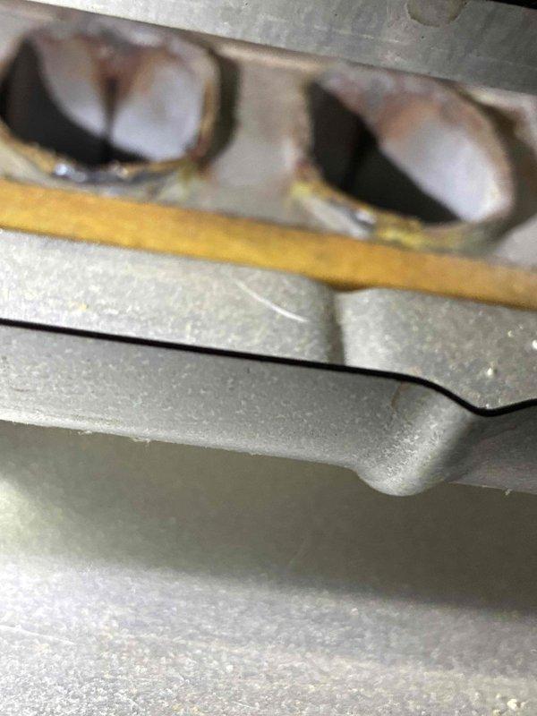 Responded to service call for 1996 Lennox furnace with reported noise issue. Upon inspection, identified signs of heat exchanger deterioration with visible discoloration around burner ports and age-related oxidation on metal surfaces. Documented condition of curved heat exchanger tubes showing accumulated dust and wear consistent with 28-year-old unit, indicating potential safety concerns and end-of-service-life conditions requiring replacement recommendation.