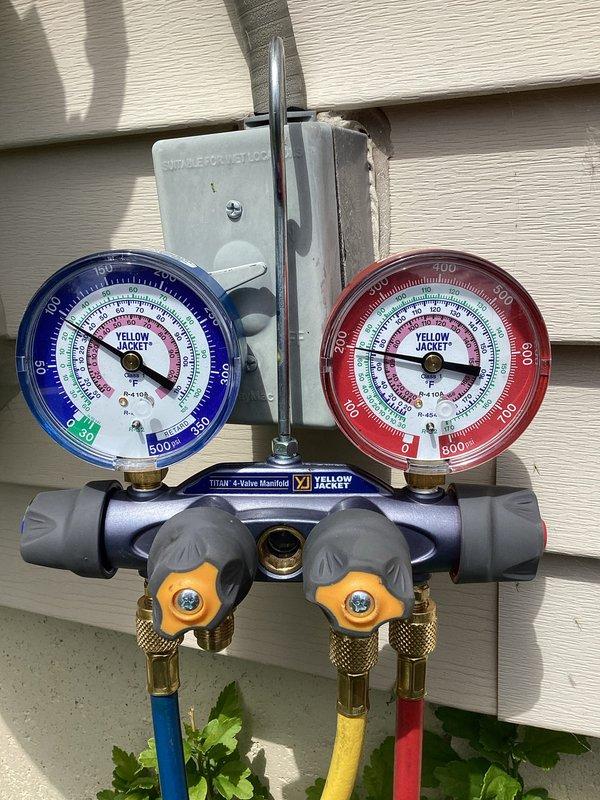 Completed annual tune-up on residential air conditioning system. Connected manifold gauge set to measure refrigerant pressures and verify system operation within manufacturer specifications. All refrigerant levels confirmed adequate, unit cycling properly with no leaks detected.