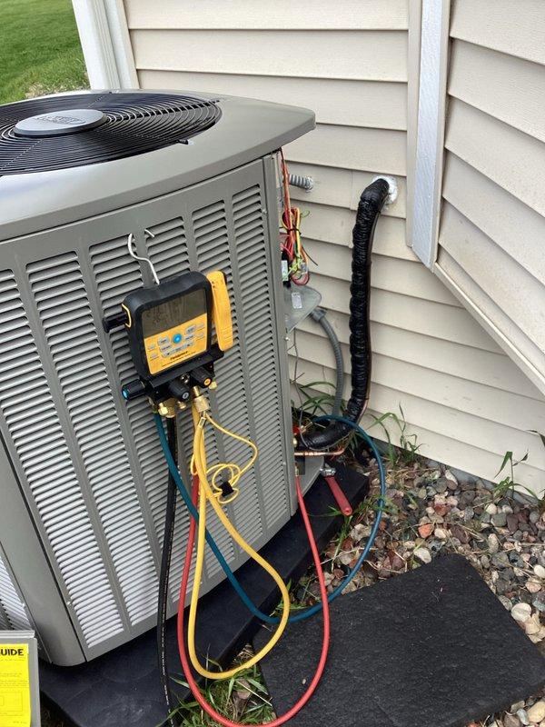 Completed full installation of new air conditioning condenser unit and evaporator coil system at residential property. Unit was properly positioned on concrete pad with appropriate clearances from structure, all refrigerant lines connected and insulated, electrical connections completed per manufacturer specifications, and system charged with refrigerant. Performed startup procedures, verified proper operation of compressor and fan motor, checked refrigerant pressures and temperatures using manifold gauges to ensure optimal system performance, and confirmed all connections were secure with no leaks detected.