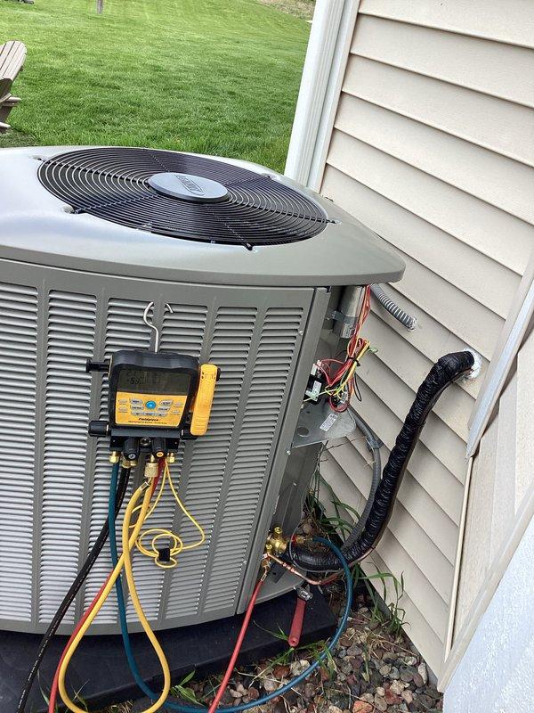 Completed full installation of new air conditioning condenser unit and evaporator coil system at residential property. Unit was properly positioned on concrete pad with appropriate clearances from structure, all refrigerant lines connected and insulated, electrical connections completed per manufacturer specifications, and system charged with refrigerant. Performed startup procedures, verified proper operation of compressor and fan motor, checked refrigerant pressures and temperatures using manifold gauges to ensure optimal system performance, and confirmed all connections were secure with no leaks detected.
