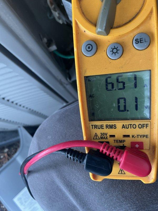 Performed comprehensive AC tune-up including non-chemical coil cleaning and full system check with panel inspection. Verified electrical readings using multimeter, measuring voltage at 236V and amperage at 23A with temperature reading of 86.1°F at outdoor condenser unit, confirming system operating within normal parameters. Applied UV light treatment with member discount and verified thermostat functionality through mobile application interface.
