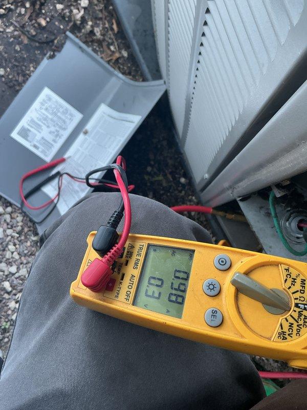 Performed comprehensive AC tune-up including non-chemical coil cleaning and full system check with panel inspection. Verified electrical readings using multimeter, measuring voltage at 236V and amperage at 23A with temperature reading of 86.1°F at outdoor condenser unit, confirming system operating within normal parameters. Applied UV light treatment with member discount and verified thermostat functionality through mobile application interface.