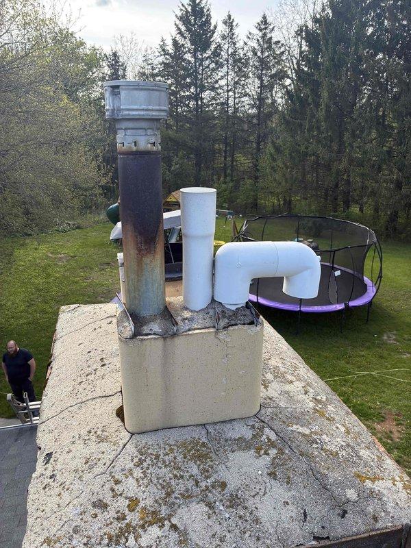 Conducted on-site estimate for replacement of 13-year-old two-stage furnace and air conditioning system located in basement. Performed visual inspection of existing HVAC equipment and assessed rooftop venting infrastructure, noting aged metal flue pipe with significant rust and corrosion requiring replacement during system upgrade.