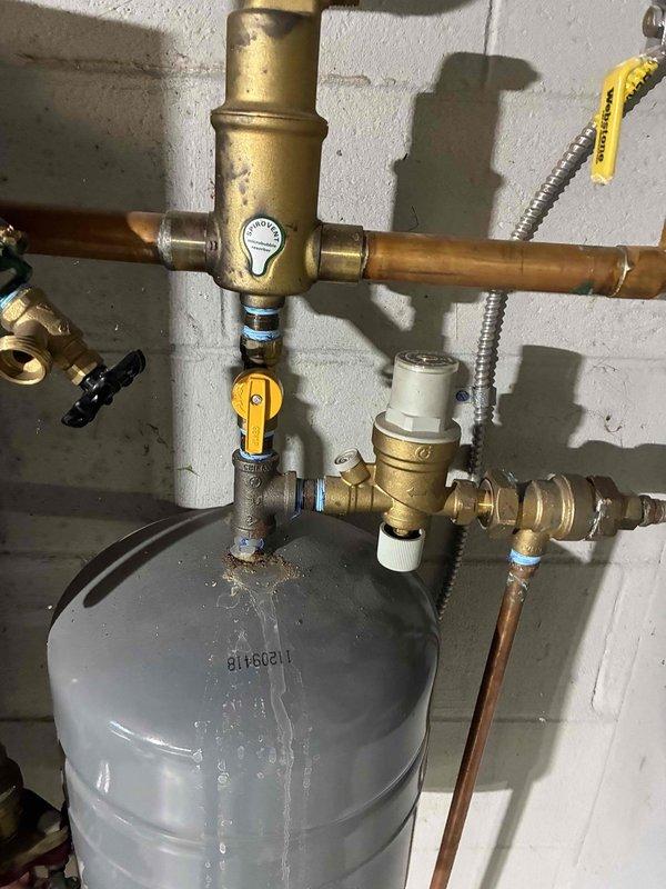Performed annual boiler tune-up and maintenance service. Reset the ATT7 reminder light on the system control panel to clear the maintenance alert. Inspected boiler components including expansion tank, piping connections, valves, and pressure relief assembly. All primary heating system components found to be operational with expansion tank and valve manifold functioning as designed. System returned to normal operation upon completion of scheduled maintenance.