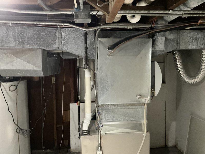 Conducted on-site assessment for mini split system installation in residential property. Evaluated existing HVAC infrastructure in basement utility area, documenting current ductwork configuration, mechanical components, and available mounting locations for indoor and outdoor units. Photographed installation area to determine optimal equipment placement and identify any potential obstacles for refrigerant line routing and electrical connections.
