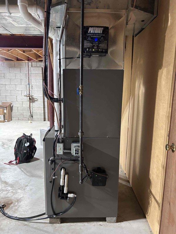 Completed full HVAC system installation including new furnace, air conditioning unit, and F100 air filtration system. Installed new air handler with vertical configuration in basement utility area, connected refrigerant line set with proper insulation, and integrated all ductwork connections. All equipment mounted, electrical connections completed, condensate drainage established, and system tested for proper operation.