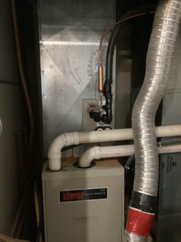 Responded to no-cooling call on Lennox Elite Series air conditioning system. Upon arrival, performed diagnostic inspection of indoor air handler unit. Confirmed system was not powering on as reported. Removed access panel to inspect internal components, wiring connections, and control board. Checked electrical connections at unit and verified proper voltage supply to equipment. Inspected condensate drainage system including PVC drain lines for potential safety switch activation due to blockage. Evaluated blower motor, capacitor, and transformer functionality. Identified root cause of no-power condition and restored system to proper operation. Tested unit through complete cooling cycle to verify successful repair and proper system function.