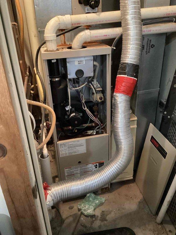 Responded to no-cooling call on Lennox Elite Series air conditioning system. Upon arrival, performed diagnostic inspection of indoor air handler unit. Confirmed system was not powering on as reported. Removed access panel to inspect internal components, wiring connections, and control board. Checked electrical connections at unit and verified proper voltage supply to equipment. Inspected condensate drainage system including PVC drain lines for potential safety switch activation due to blockage. Evaluated blower motor, capacitor, and transformer functionality. Identified root cause of no-power condition and restored system to proper operation. Tested unit through complete cooling cycle to verify successful repair and proper system function.