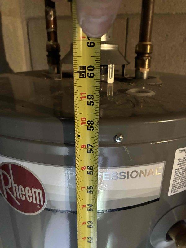 Conducted on-site assessment of existing Rheem water heater in basement mechanical room to provide replacement estimate. Unit is currently operational but has reached end of expected service life based on age and condition. Documented existing installation including height measurements, copper supply line connections, and current venting configuration. Photographed equipment specifications, clearances, and surrounding utility area to determine replacement requirements and ensure proper sizing for new unit installation.