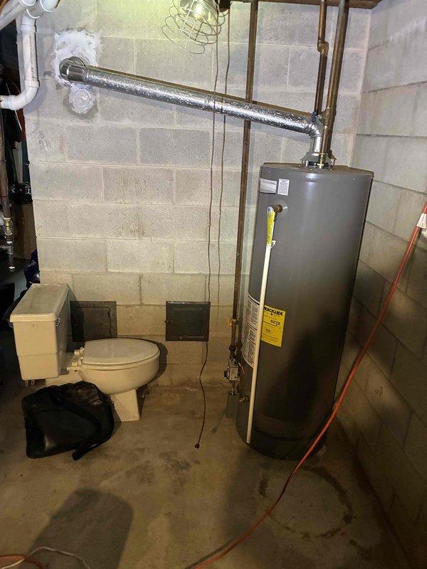 Conducted on-site assessment of existing Rheem water heater in basement mechanical room to provide replacement estimate. Unit is currently operational but has reached end of expected service life based on age and condition. Documented existing installation including height measurements, copper supply line connections, and current venting configuration. Photographed equipment specifications, clearances, and surrounding utility area to determine replacement requirements and ensure proper sizing for new unit installation.