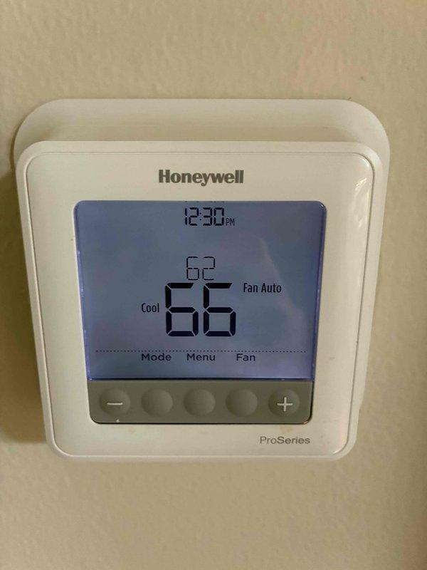 Completed routine cooling system maintenance visit as part of membership agreement. Upon inspection, found significant organic debris and biological growth accumulation in the condensate drain pan requiring cleaning. Verified thermostat operation showing proper temperature control at 66°F with system in cooling mode, checked capacitor connections and wiring integrity, and inspected refrigerant lines and evaporator coil condition.