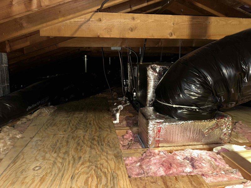 Conducted estimate for replacement of existing attic-mounted air handler unit. Inspected current equipment and attic installation conditions, documenting electrical panel configuration with main disconnect and circuit breaker arrangement, as well as existing ductwork layout including black flexible ducts and silver reflective insulation materials. Provided mid-range equipment replacement options to meet customer requirements for reliable performance without premium-tier pricing.
