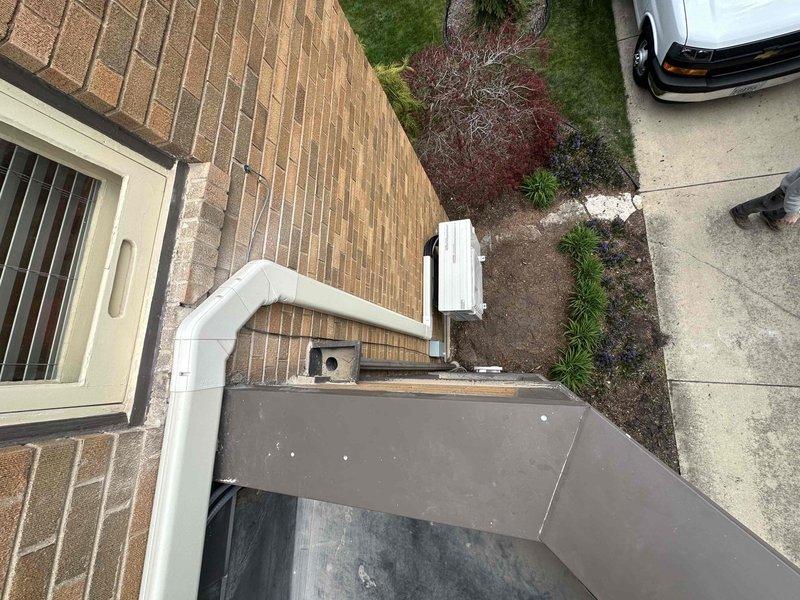 Completed mini-split system installation at residential property. Installed outdoor condenser unit on exterior brick wall with proper refrigerant line set routing and drainage system using white PVC piping. Mounted indoor air handler unit in interior closet space with electrical connections, verified proper operation of all components, and conducted system testing to ensure optimal performance.