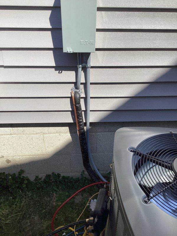 Completed full HVAC system installation including new air conditioning condenser unit and furnace. Installed outdoor condensing unit on concrete pad with proper clearances from structure, mounted Eaton electrical disconnect box to exterior wall, and ran gray PVC conduit for electrical connections. Routed refrigerant line sets with insulation between outdoor and indoor units. System was pressure tested, evacuated, and charged to manufacturer specifications. All electrical connections completed per code requirements, unit tested and confirmed operational with proper airflow and cycling.