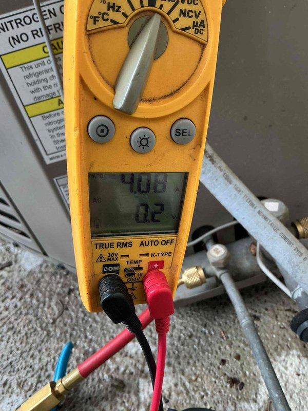 Completed annual tune-up on 2007 HVAC system. Inspected evaporator coil through air handler access, confirmed clean condition with no debris buildup on fins. Performed electrical diagnostics using digital multimeter, recorded voltage readings of 40.6V and 0.2V at critical system points to verify proper operation and electrical integrity of unit components.