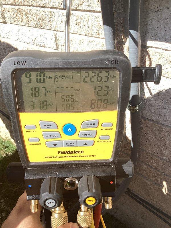 Completed air conditioning system startup and commissioning on newly installed unit. Performed comprehensive system diagnostics using digital manifold gauge set, recording refrigerant pressures and temperatures across the system. High side pressure measured at 910 psig with 226.5°F temperature, low side pressure at 18.4 psig with 123°F temperature, indicating proper refrigerant charge and system operation. Verified supply air temperature at 40.6°F at the ductwork, confirming adequate cooling capacity and proper airflow through the evaporator coil. All system parameters within manufacturer specifications, unit operating as designed with no deficiencies noted.