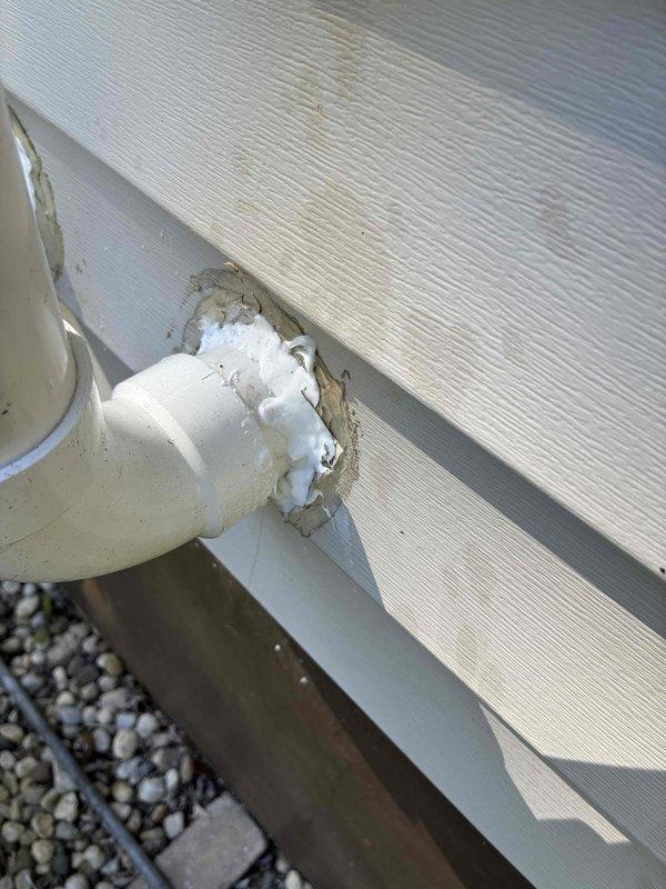 Responded to callback regarding recent installation quality concerns. Verified thermostat level alignment using torpedo level and documented exterior condensate line penetration with expanding foam sealant. Photographed both items for quality assurance review and advised customer that invoice will be mailed following this no-charge service visit.