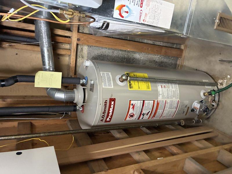Responded to no hot water complaint at property that had been vacant for several months. Inspected 40-gallon A.O. Smith gas water heater installed in 2019 located in attic space. Found pilot light extinguished, likely due to extended period of non-use. Relit pilot light, verified proper ignition sequence, and confirmed burner operation. Tested hot water delivery at fixtures and verified system returned to normal operation with adequate temperature and pressure.