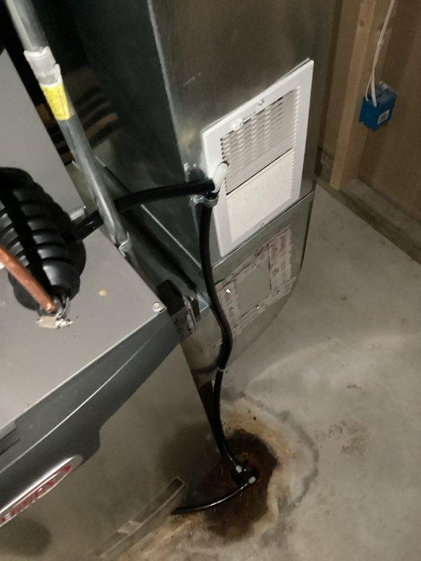 Completed installation of new air conditioning system and evaporator coil in residential basement location. Unit was properly positioned, connected to existing ductwork with flexible black ducting, and integrated with furnace system. All refrigerant lines, electrical connections, and condensate drainage were installed per manufacturer specifications, with system tested and confirmed operational upon completion.