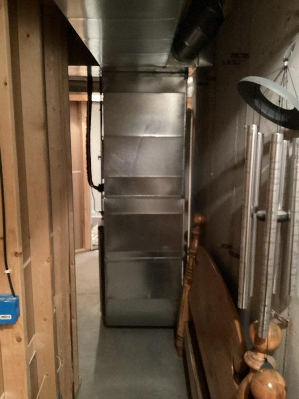 Completed full HVAC system installation including furnace and air conditioning unit. Interior work included installation of furnace with metal ductwork system in basement utility area, with proper integration into existing structure and copper refrigerant line routing. Exterior work included placement of condenser unit on rubber isolation pad with gravel base against house siding, with electrical conduit run and all refrigerant lines properly connected. Licensed electrician handled all electrical connections, and all required permits were obtained for the installation.