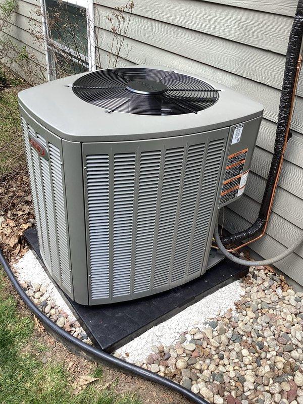 Completed full HVAC system installation including furnace and air conditioning unit. Interior work included installation of furnace with metal ductwork system in basement utility area, with proper integration into existing structure and copper refrigerant line routing. Exterior work included placement of condenser unit on rubber isolation pad with gravel base against house siding, with electrical conduit run and all refrigerant lines properly connected. Licensed electrician handled all electrical connections, and all required permits were obtained for the installation.