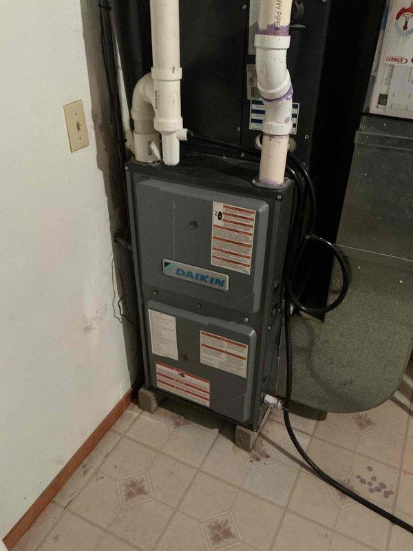 Completed air conditioning tune-up on Daikin air handler system. Performed comprehensive system inspection including electrical testing with digital multimeter to verify proper voltage and amperage readings at control board connections. Documented equipment condition and operational status with photos showing air handler installation, condensate drain piping, and electrical components functioning within manufacturer specifications.