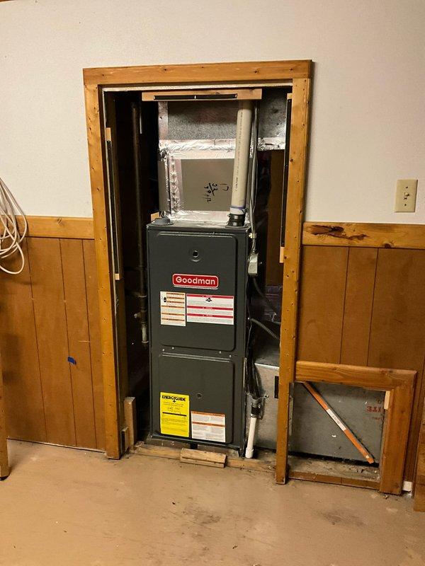 Provided comprehensive estimate for replacement of aging Goodman furnace and air conditioning system located in basement installation. Current equipment is operational but customer requested proactive replacement to avoid future reliability concerns. Documented existing vertical furnace configuration with ductwork connections and electrical service panel for replacement specifications.