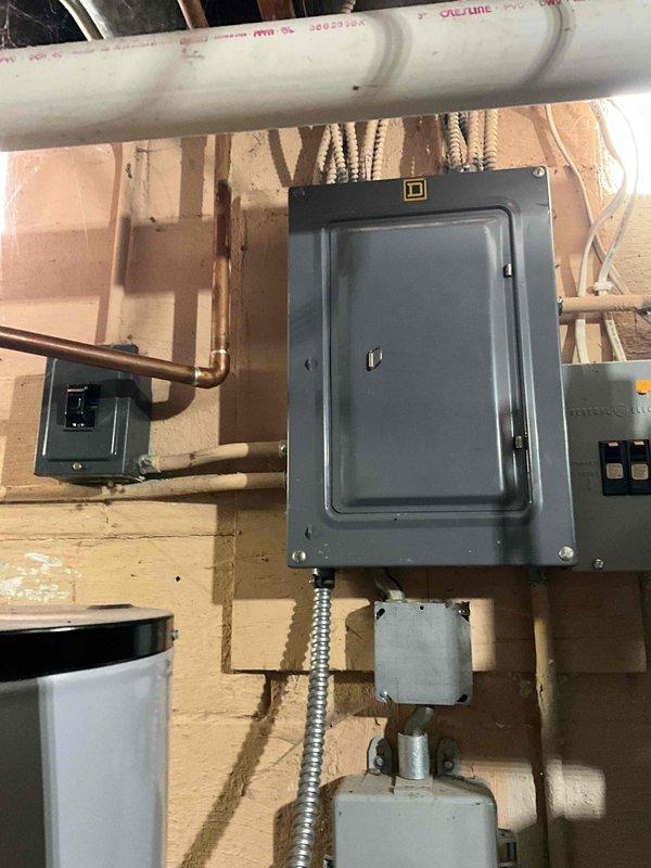 Provided comprehensive estimate for replacement of aging Goodman furnace and air conditioning system located in basement installation. Current equipment is operational but customer requested proactive replacement to avoid future reliability concerns. Documented existing vertical furnace configuration with ductwork connections and electrical service panel for replacement specifications.