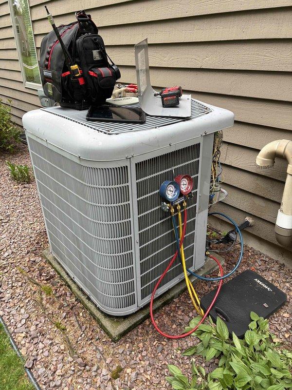 Completed air conditioning and furnace tune-up on residential HVAC system. Performed standard maintenance procedures including pressure testing with manifold gauges on outdoor condenser unit and inspection of indoor air handler in basement mechanical room. System requires PGAPXCAR2025-AD2 filter replacement, sized 10x12.