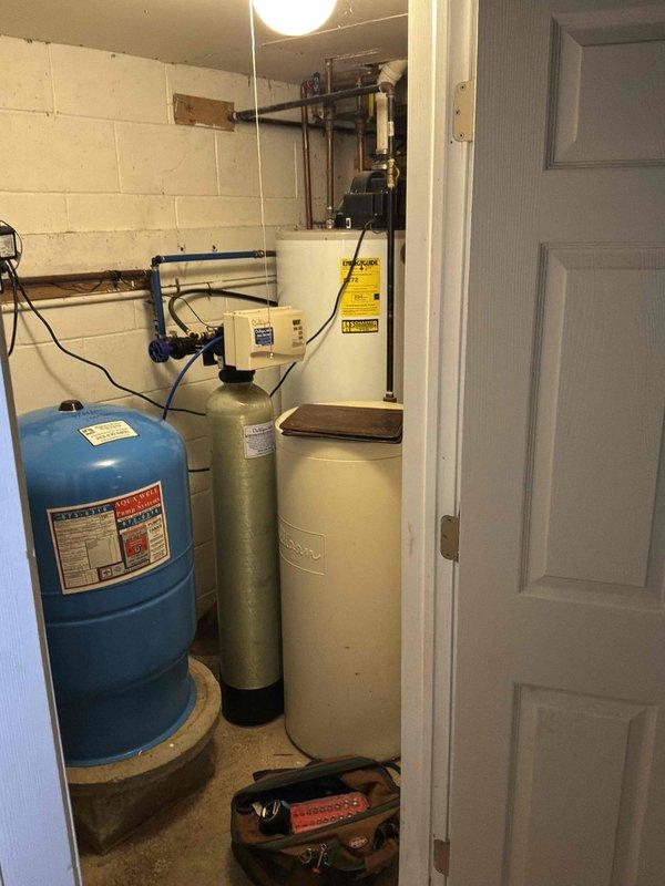 Completed estimate for water heater replacement in residential basement utility room. Assessed existing water heater installation, connections, and surrounding plumbing infrastructure including pressure tank and water softening system. Documented current equipment configuration with copper supply lines, shutoff valves, and drainage connections. Coordinated installation scheduling to accommodate customer availability, with arrangements made for authorized representative to be present during replacement. Confirmed 12-1 arrival window and established communication protocol for day-of-service contact.