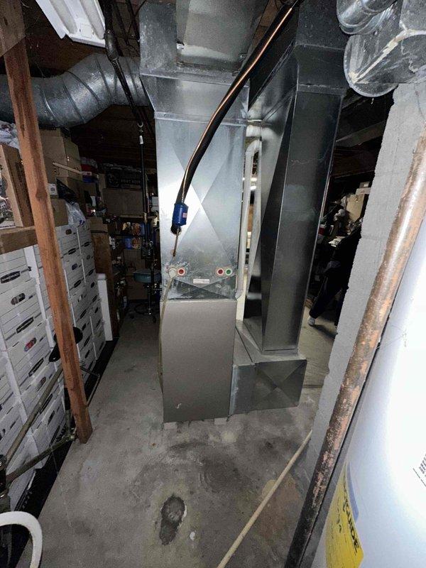 Completed estimate for replacement of existing Carrier Infinity air conditioning system and furnace. Customer reported non-functional AC unit but indicated no immediate cooling needs due to current weather conditions. Assessed existing Carrier Infinity HVAC equipment located in basement mechanical room, including furnace with associated ductwork and copper refrigerant lines. Documented equipment condition through photos showing current system configuration, sheet metal ductwork, and installation layout. Provided pricing options for AC replacement as primary need and furnace replacement as secondary consideration based on customer preference for maintaining Carrier Infinity brand equipment.