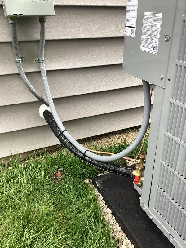 Completed full HVAC system installation including new outdoor air conditioning unit with associated coil and Honeywell Home digital thermostat. Installed exterior condensing unit on composite equipment pad with proper electrical disconnect and conduit connections, established refrigerant line sets between outdoor and indoor components, and mounted programmable thermostat on interior wall for system control and temperature management.