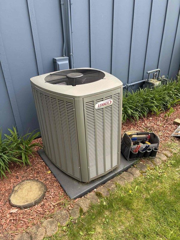 Completed standard AC tune-up on Lennox outdoor condensing unit. Removed significant accumulation of mulch and organic debris from condenser drain pan that had collected around compressor housing and piping. Performed routine maintenance inspection of system components, checked refrigerant lines, and verified unit operation.