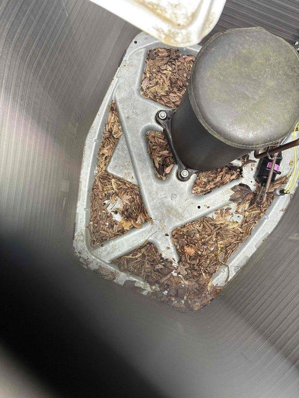 Completed standard AC tune-up on Lennox outdoor condensing unit. Removed significant accumulation of mulch and organic debris from condenser drain pan that had collected around compressor housing and piping. Performed routine maintenance inspection of system components, checked refrigerant lines, and verified unit operation.