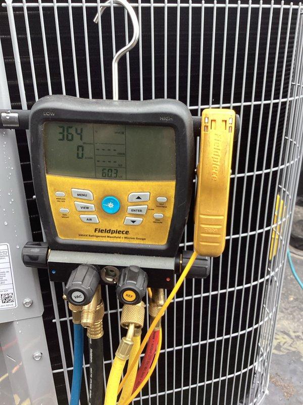 Completed installation of Carrier air conditioning system with matching evaporator coil. System was charged with refrigerant and tested using digital manifold gauges, confirming proper operating pressures and temperatures across both high and low sides. All connections were verified leak-free, electrical disconnect installed, and unit commissioned to manufacturer specifications for optimal performance.