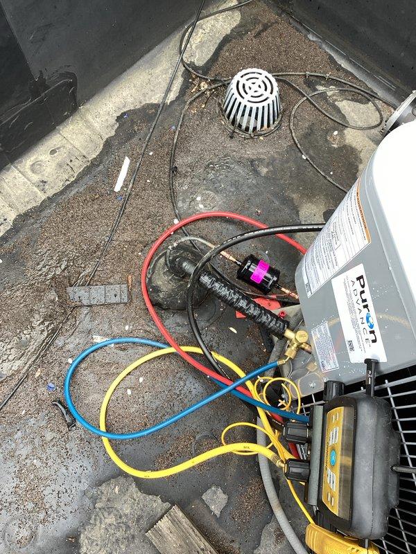Completed installation of Carrier air conditioning system with matching evaporator coil. System was charged with refrigerant and tested using digital manifold gauges, confirming proper operating pressures and temperatures across both high and low sides. All connections were verified leak-free, electrical disconnect installed, and unit commissioned to manufacturer specifications for optimal performance.