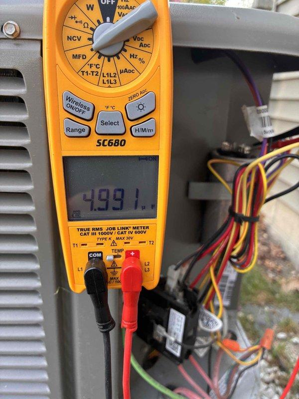 Completed prepaid membership cooling maintenance visit on residential HVAC system. Performed comprehensive inspection of outdoor condensing unit, revealing significant accumulation of dirt, dust, and debris on condenser coil fins and between fin spaces. Conducted electrical diagnostics using digital multimeter, obtaining capacitor reading of 499.1 MFD to verify proper system operation. Assessed condition of fan motor assembly, wiring connections, and internal components. Documented heavy debris buildup on cooling fins that may impact system efficiency and recommended cleaning to maintain optimal performance. All electrical measurements within acceptable parameters. System operational upon completion of inspection.