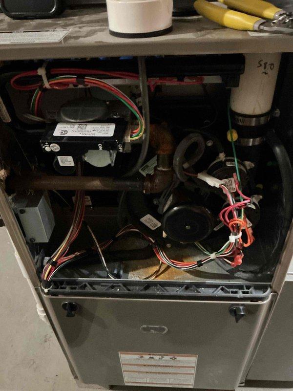 Completed comprehensive tune-up service on residential furnace and air conditioning system. Performed refrigerant pressure testing on the AC unit using manifold gauges, confirming proper R-404A refrigerant levels and system operation. Inspected furnace interior components including blower motor assembly, electrical connections, capacitor, and wiring harnesses to ensure all systems are functioning safely and efficiently for the upcoming season.