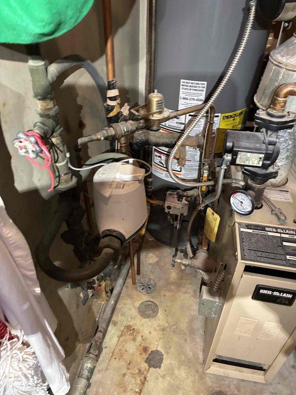 Completed recurring membership heating maintenance visit on Weil-McLain gas boiler system. Performed standard inspection of boiler unit, verified pressure gauge readings, and inspected all copper piping, flexible connectors, and valve assemblies for proper operation. Reconfigured thermostat settings to control heating only, as air conditioning system has been removed and will not be replaced.
