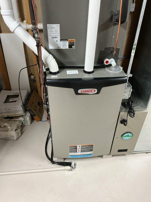 Completed air conditioning tune-up and system performance evaluation. Connected manifold gauges to measure refrigerant pressures and verify proper system operation. Inspected Lennox furnace unit, checked electrical connections, and confirmed all safety labels and components were in proper working order.