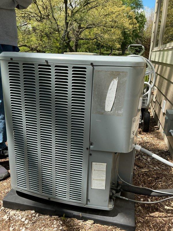 Responded to service call for outdoor heat pump unit. Performed comprehensive tune-up maintenance including refrigerant system diagnostics using manifold gauges and pressure testing equipment. Unit showed signs of age and weathering with visible exterior repair patch, but system operated within acceptable parameters upon completion of service and testing.