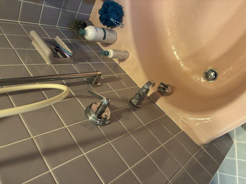 Responded to no hot water issue in primary bathroom shower/tub. Upon inspection, found mineral buildup had locked the mixing valve in place, preventing hot water flow to the fixture. Disassembled shower trim and faucet components to access the affected valve cartridge. Removed corroded parts and assessed the existing copper supply lines, noting narrow pipe diameter and age-related deterioration in several sections. Documented conditions of both the fixture assembly and accessible plumbing infrastructure in the crawl space above, including supply line routing and connections. Provided assessment of plumbing system condition and repair options to address both the immediate hot water issue and underlying concerns with aging copper piping.