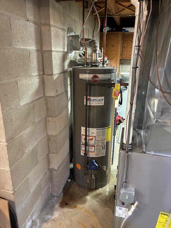 Conducted on-site assessment of leaking 50-gallon gas water heater in basement utility area. Provided detailed estimate for complete water heater replacement, including removal of existing Rheem unit, installation of new 50-gallon gas water heater with proper venting through existing flue system, and connection to existing copper supply lines and gas piping with code-compliant fittings and pressure relief valve.