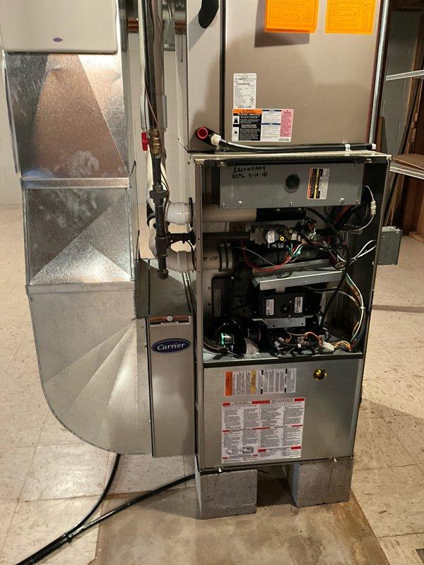 Conducted comprehensive HVAC system evaluation for furnace and air conditioning replacement estimate at residential property. Existing Carrier natural gas furnace located in basement was assessed following home inspection recommendation for replacement. Inspected internal components, ductwork configuration including triangular air distribution system, electrical connections, and condensate management system. Evaluated Carrier Infinity programmable thermostat system with multi-zone capabilities currently controlling HVAC operations. Documented equipment condition and discussed installation requirements with homeowner who requested premium installation service with scheduled arrival window and advance notification.